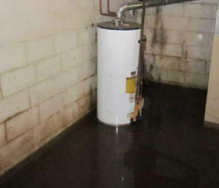 A basement that has water damage from a storm is shown