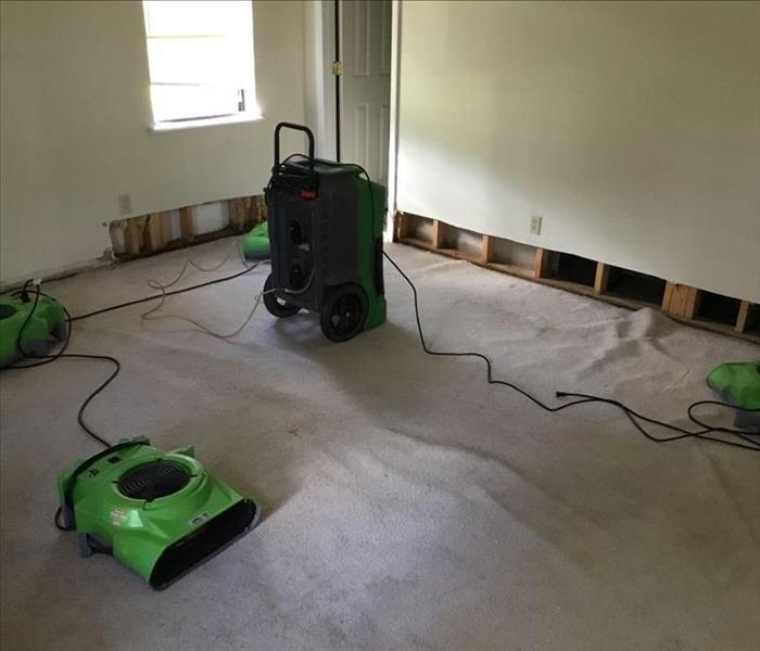Water damage occurred and green SERVPRO fans placed to dry out room.